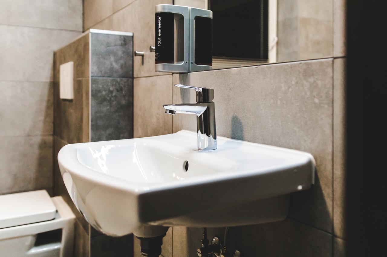 Silesia Residence Ostrava Eksteriør billede A soap dispenser mounted above a sink